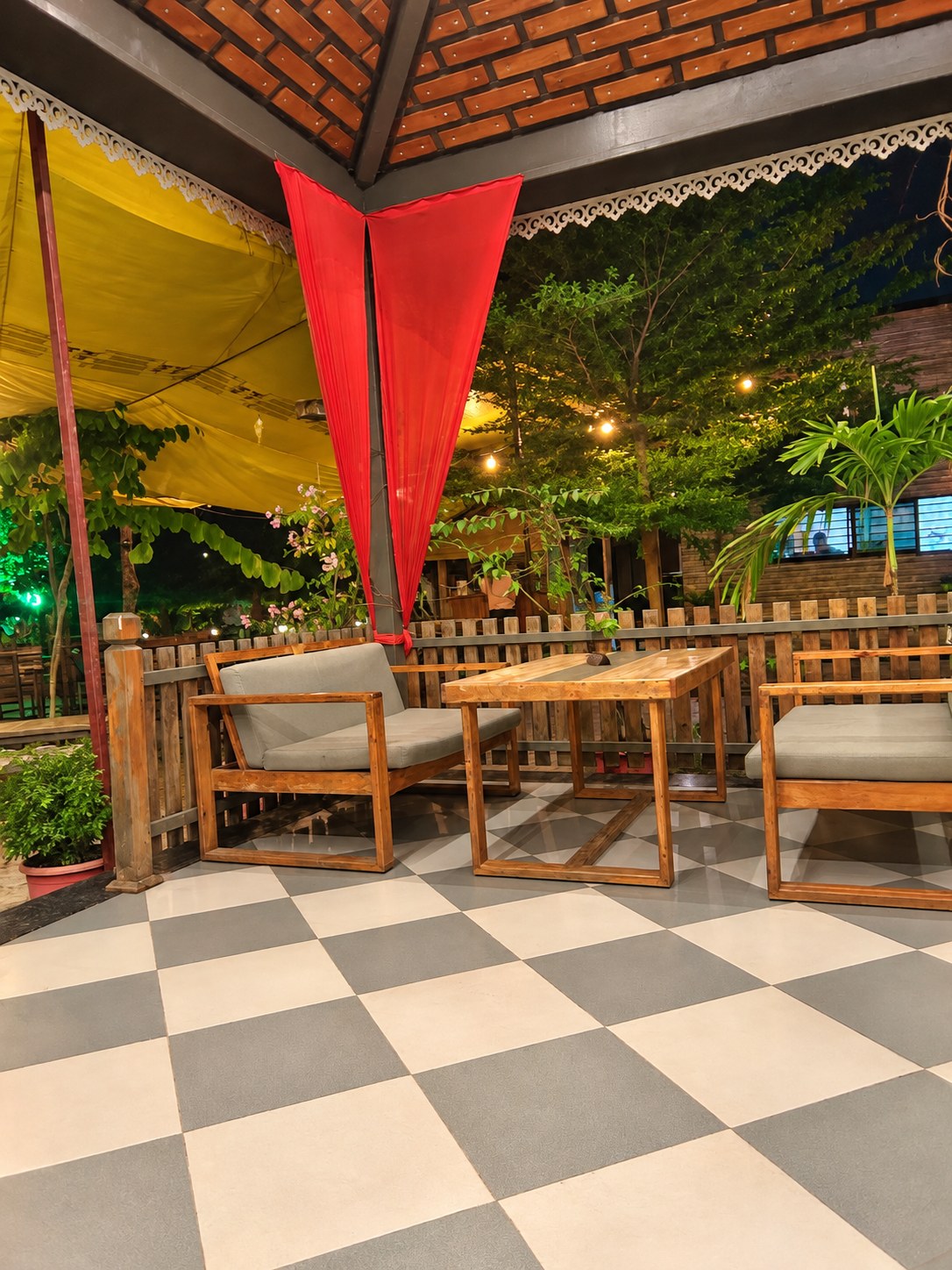 Wooden tables and chairs beneath the garden gazebo