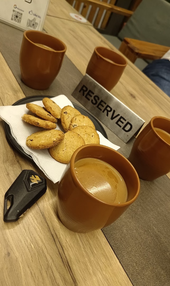 Kulhad chai and cookies on a reserved table